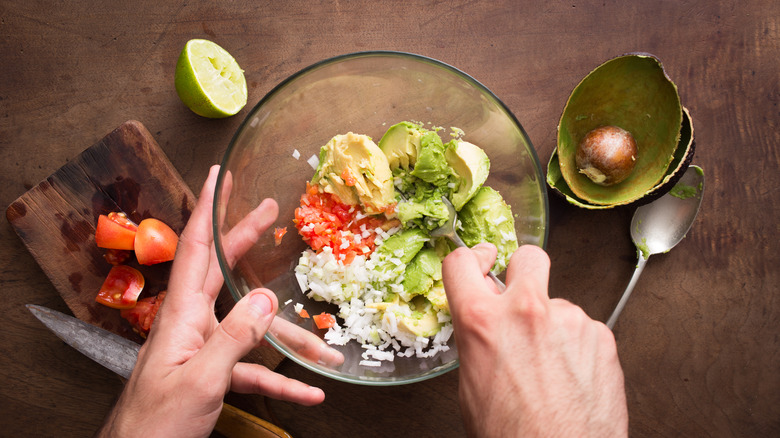 Mixing guacamole ingredients 