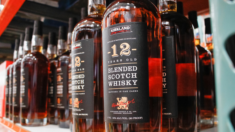 Bottles of Kirkland scotch on shelves in Costco