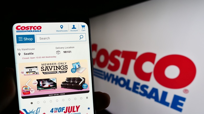 Costco sign and smartphone with Costco app open