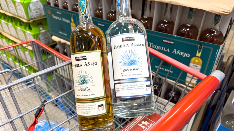 Two bottles of Kirkland Signature tequila in a shopping cart