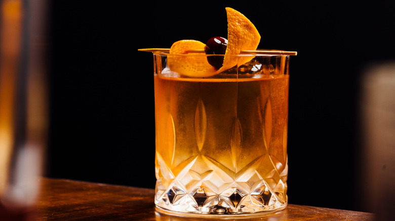 An old fashioned cocktail with orange peel garnish