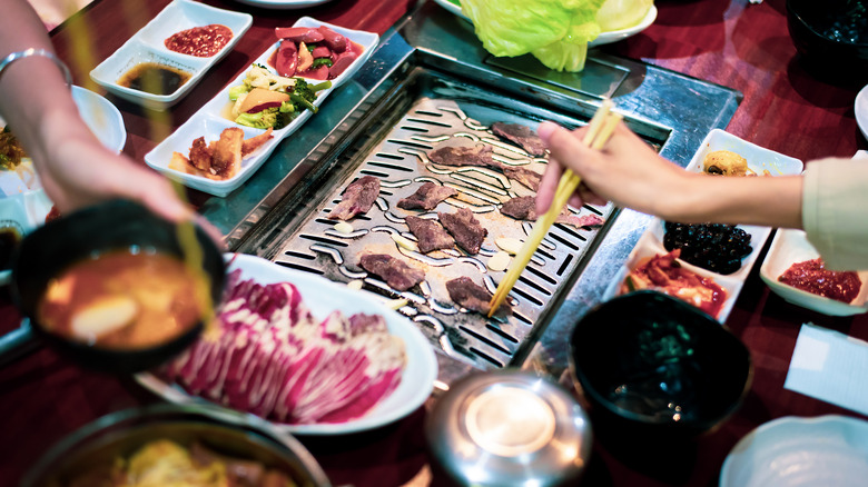 Hands cooking Korean BBQ