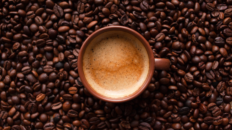 Cup of coffee, whole beans background