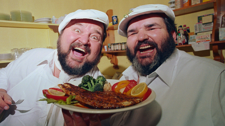 Dom DeLuise and Paul Prudhomme with blackened fish