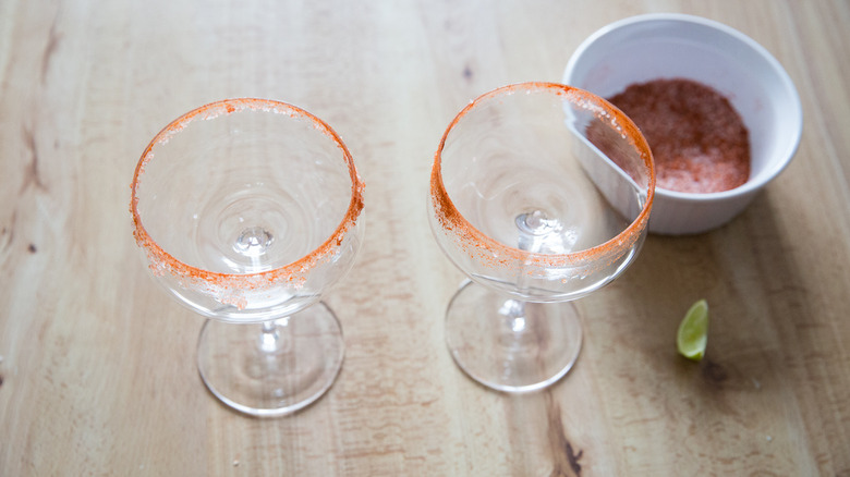 Cayenne-coated margarita glasses on table