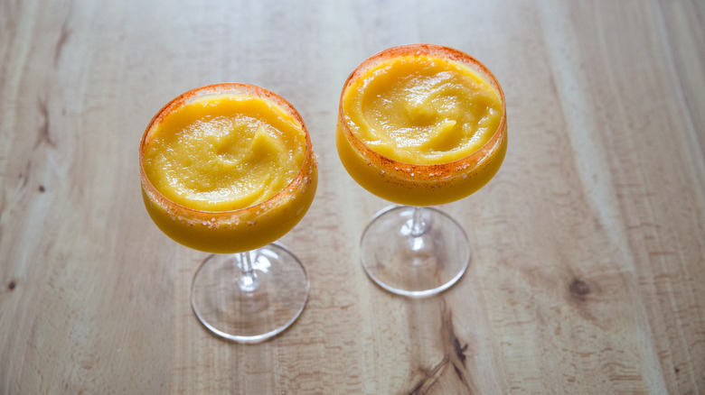 Two frozen margaritas on table