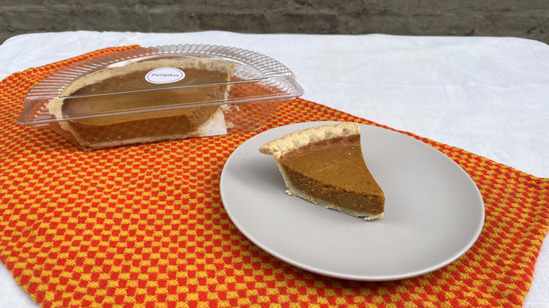 Whole Foods half pumpkin pie and slice on a plate