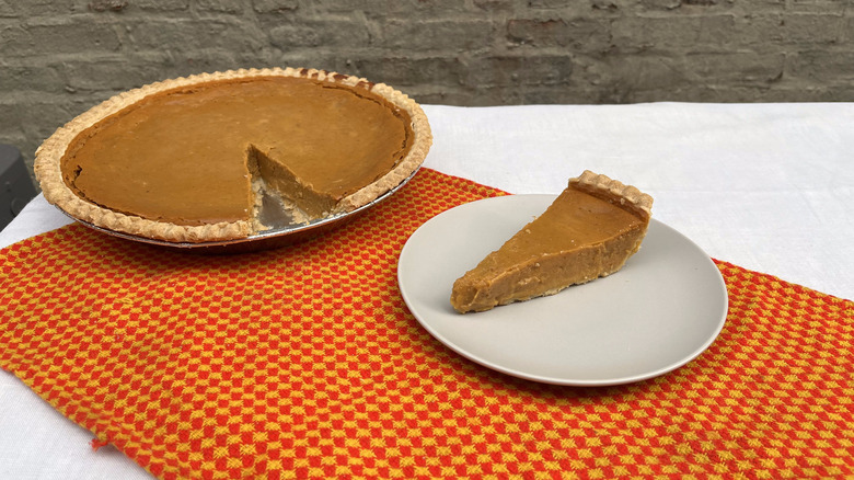 Costco pumpkin pie and slice on a plate