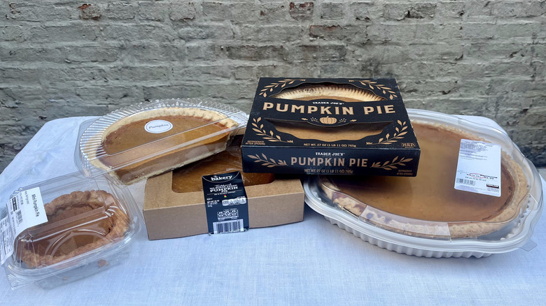 Grocery store pumpkin pies stacked on table