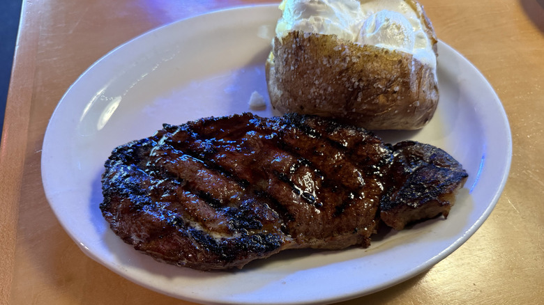 Ribeye steak with baked potato from Texas Roadhouse.