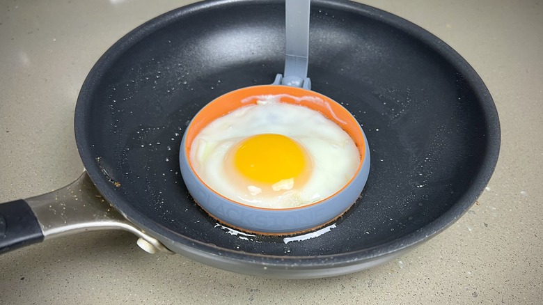 An egg frying in a silicone ring