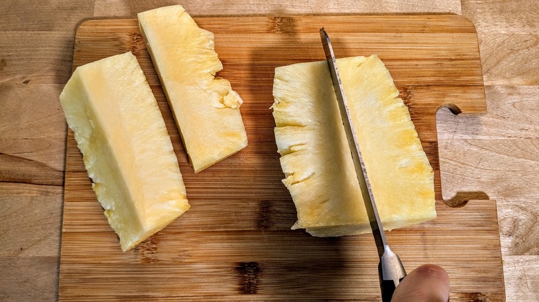 knife cutting pineapple