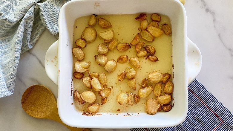 garlic and oil in white baking dish