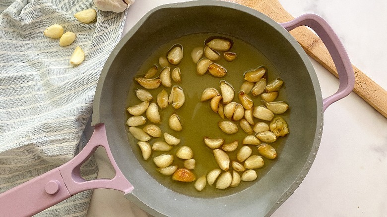 garlic cloves in frying pan