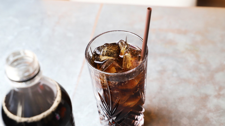 Cola in glass with straw