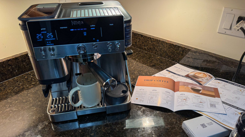 Drip coffee being made on espresso machine with guide in background