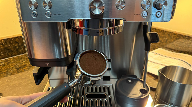 Espresso puck next to espresso machine on countertop