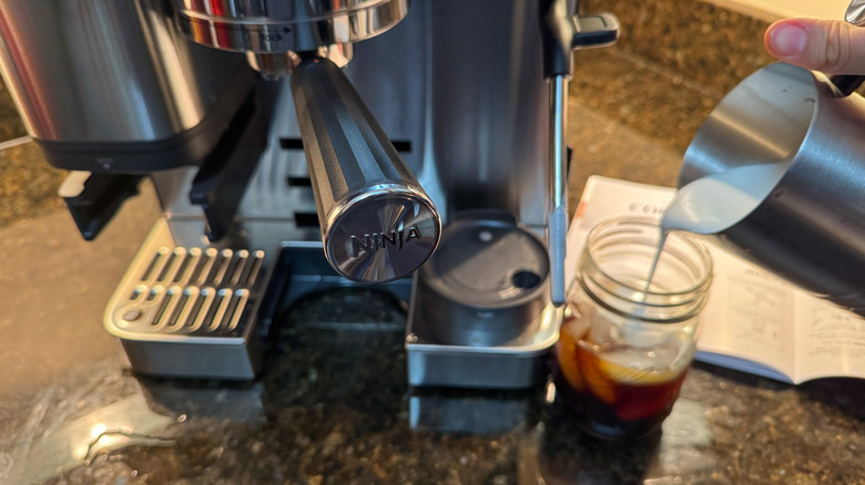 Ninja portafilter logo with person pouring cold foam in background