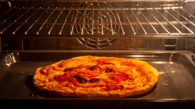 Pizza being baked on baking sheet