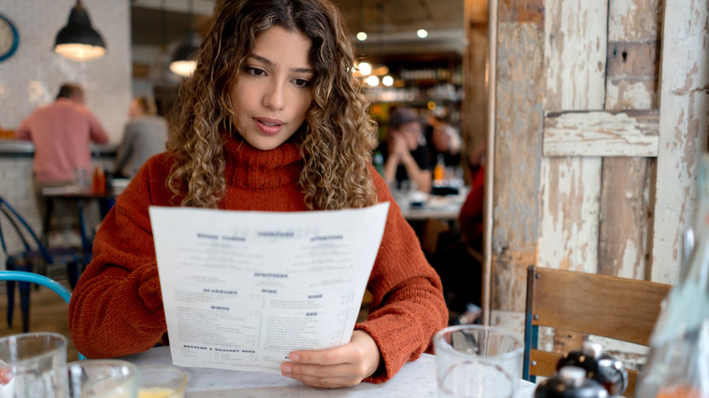 Diner reading a menu