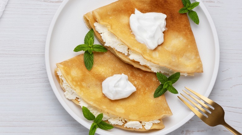 Cottage cheese-stuffed crepes on plate