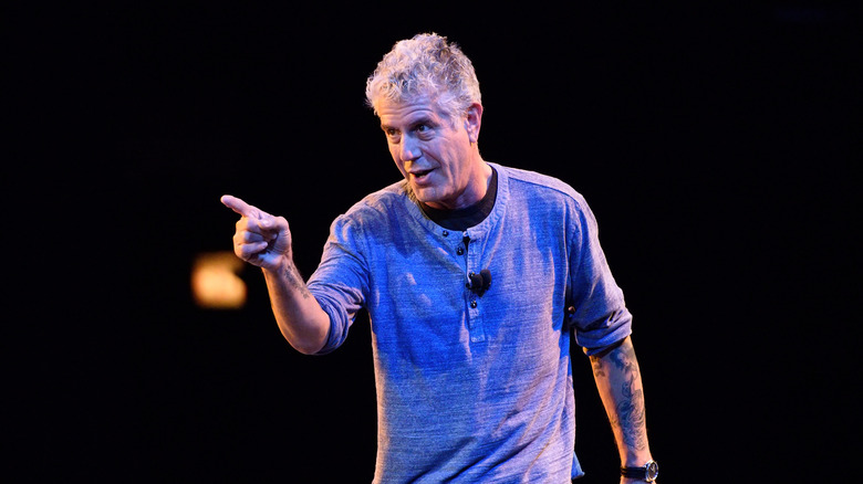 Anthony Bourdain pointing on stage