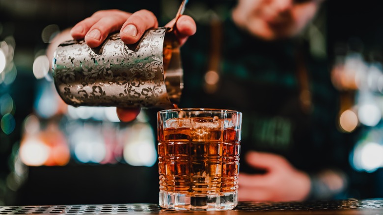 Person pouring a cocktail