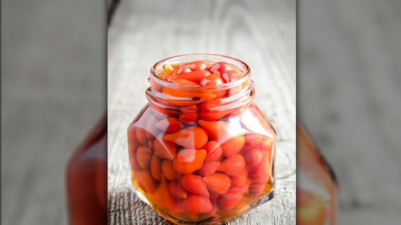 Red biquinho peppers in jar