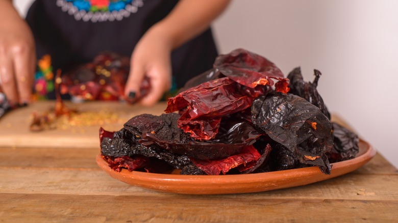 woman slicing chile peppers