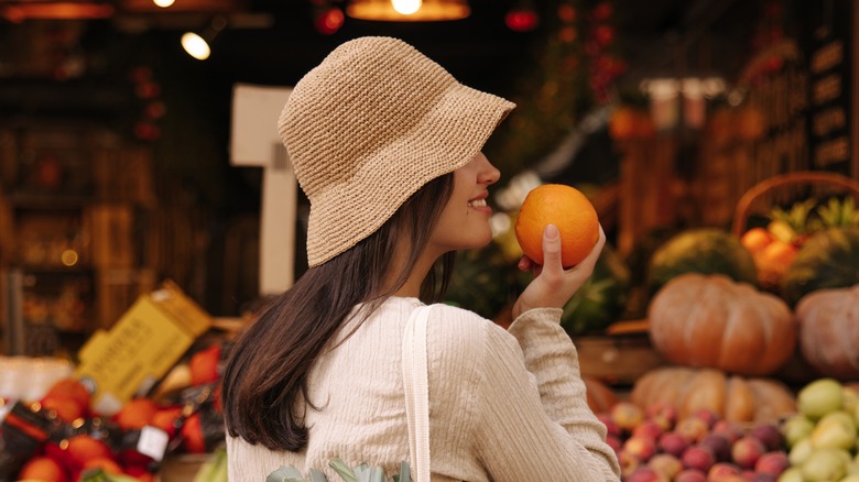 Woman smelling orange