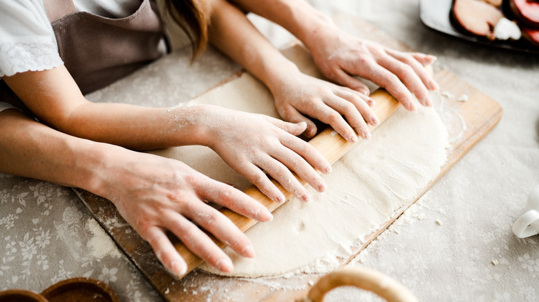 hands using rolling pin