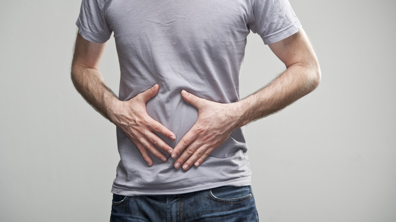 a man holding his abdominal area