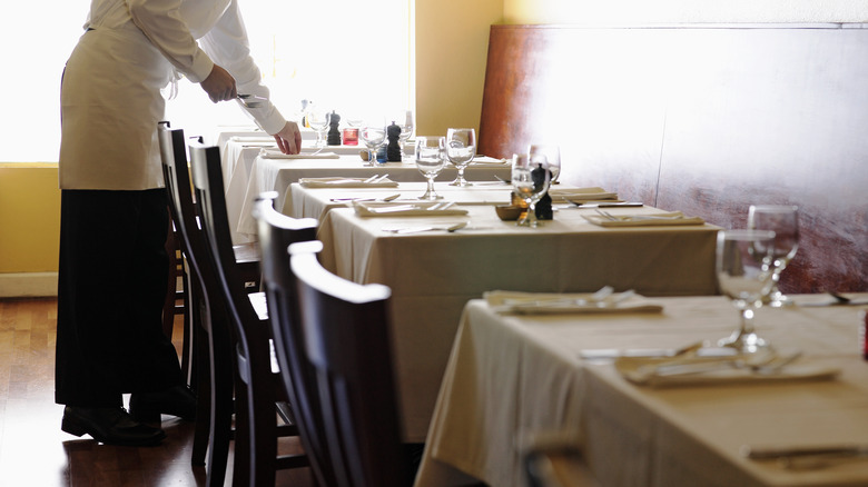 waiter preparing settings