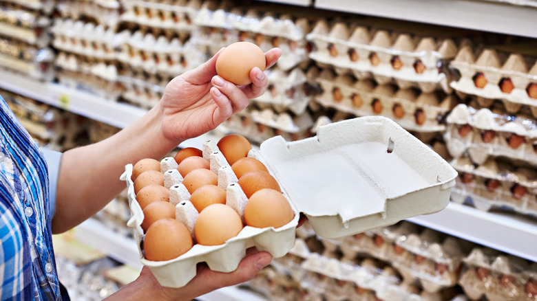 woman holding egg in hand