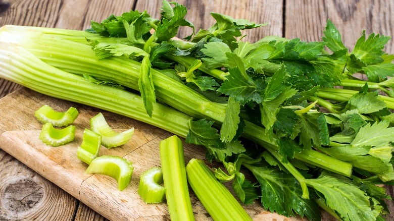 Stalks of celery on a cutting board 