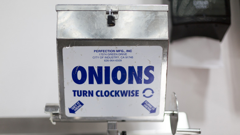 A hand-crank onion dispenser