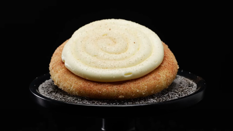 Crumbl snickerdoodle cupcake cookie on black background