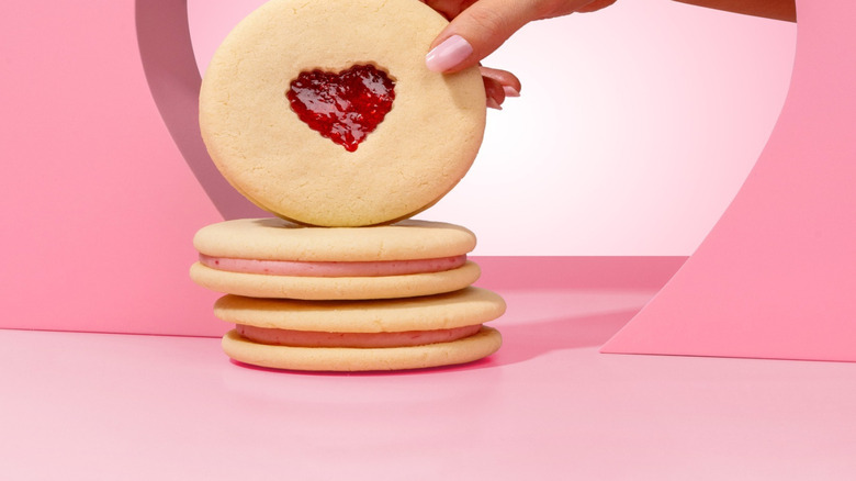 hand holding jammy heart cookie from Crumbl