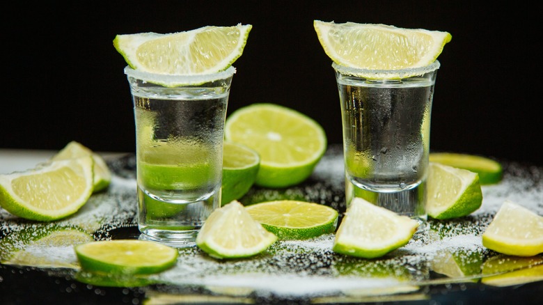 silver tequila and limes
