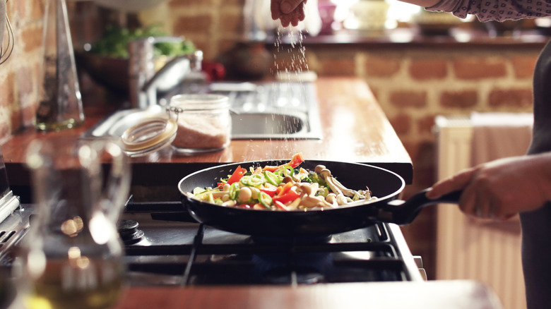 seasoning food on the stove