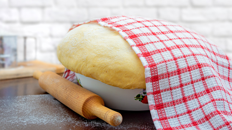 Break baked in an open dish, partly covered by a towel