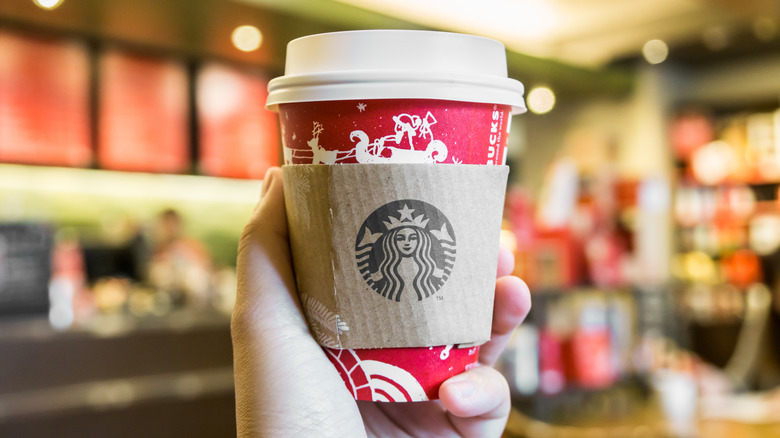 hand holding starbucks holiday drink