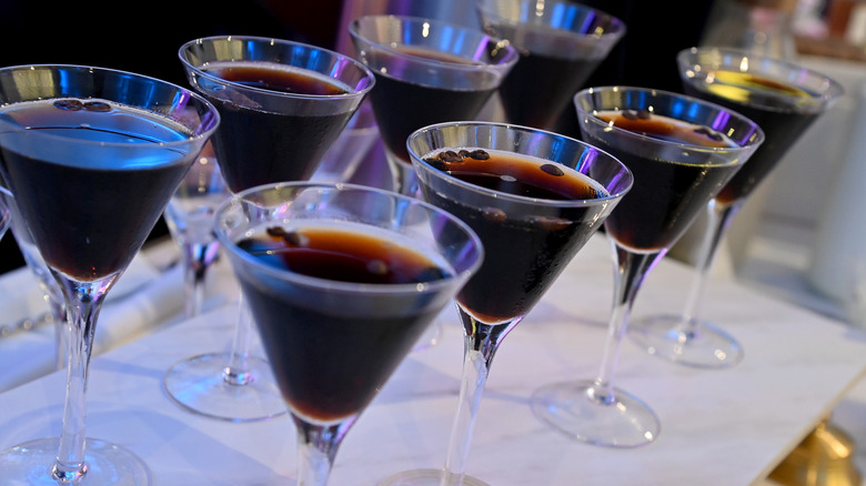 Eight glasses of espresso martinis on a counter