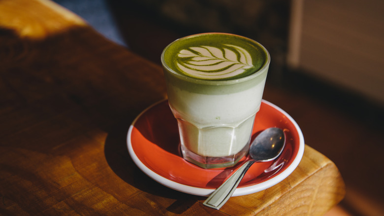 Glass of matcha on red plate