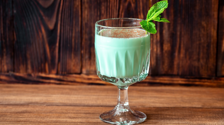 green cocktail decorated with mint