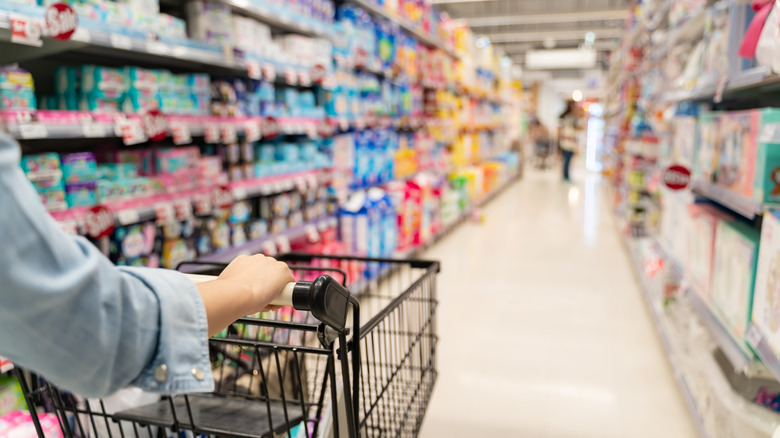 shopping cart in supermarket aisle