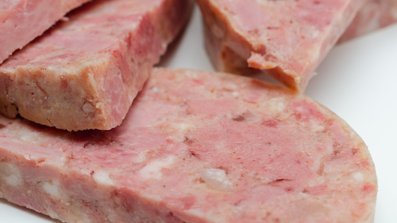 Traditional pork head cheese slices close-up