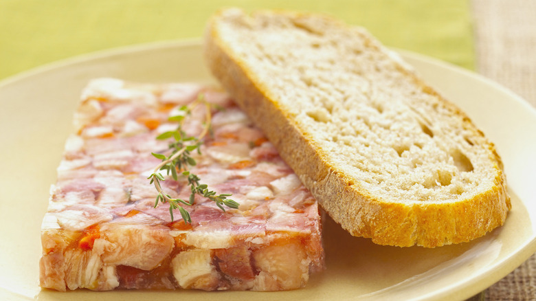 Slices of head cheese and bread on a plate