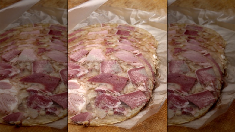 Slices of head cheese on deli paper