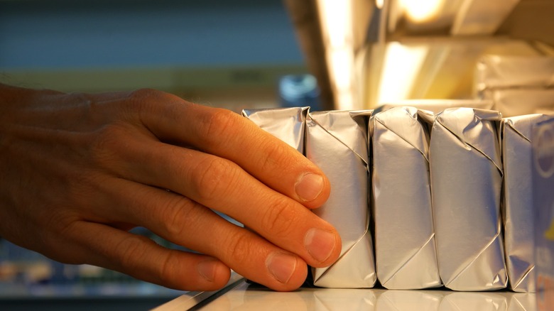 Margarine stacked on refrigerated shelf